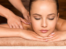 Beautiful young woman relaxing in the spa salon.