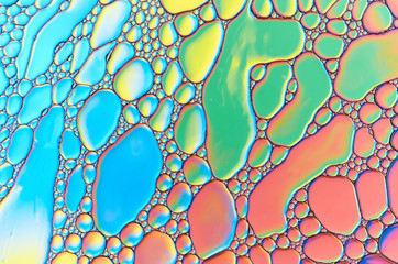 Colorful abstract images of oil drops on water. Colored circles and waves as a concept of...