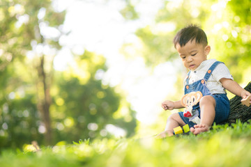 Kid child boy enjoying with nature green grass under tree