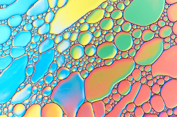 Colorful abstract images of oil drops on water. Colored circles and waves as a concept of...