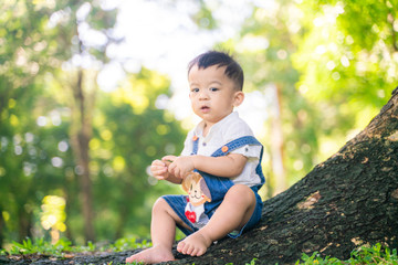 Kid child boy enjoying with nature green grass under tree