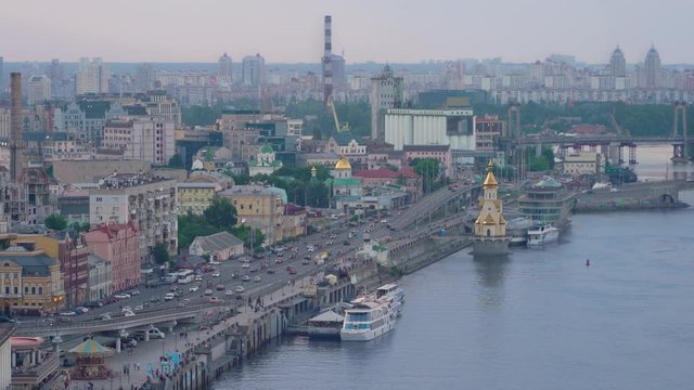 Summer cityscape of Kyiv city, The Dnipro river, Podilskyi district, Obolon, pier, embankment, river station. The Dnieper. Kiev. City traffic