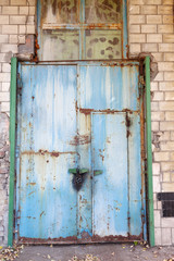 Old vintage wall with worn metal door