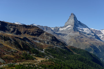 Fototapeta premium Amazing View of the mountain Matterhorn, Zermatt, Valais in the Swiss Alps, blue sky, no clouds in early autumn.
