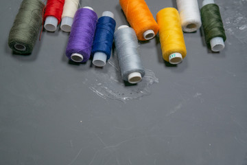 Multi-colored threads on a gray background