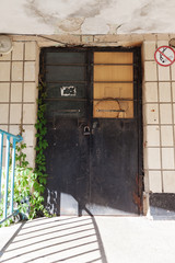  Old vintage wall with worn metal door