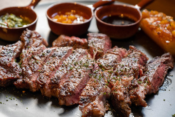 closeup beef steak with many dipping sauce