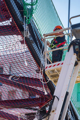Professional installation work on a construction building site. Assemblers perform high-altitude...