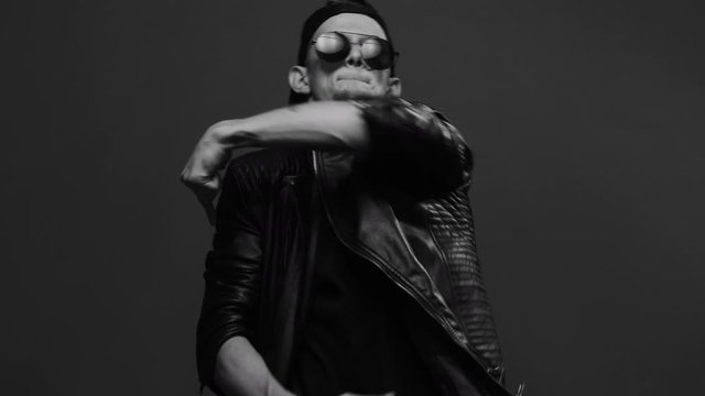 Talented young man performing cool dance. Bad guy. Stylish man in glasses emotionally dancing. Caucasian man dancing in studio. Contemporary dance. Krump. Hip hop style, listening to music