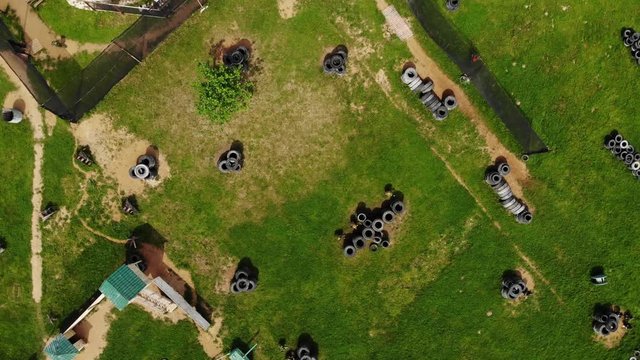 paintball players prepare for game on green battlefield