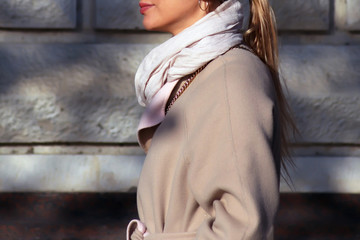 Young woman in autumn coat. Neck scarf