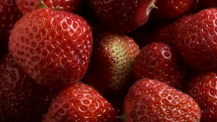 Rotation of juicy ripe strawberries. Top view, Rotation 360 degrees, closeup. 4K - 50fps