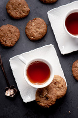 cup of tea and cookies on table