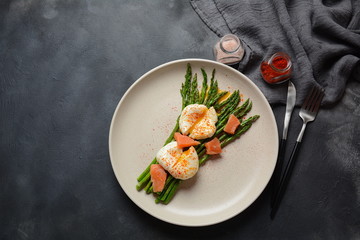 Green asparagus with poached eggs on a plate. Healthy breakfast concept