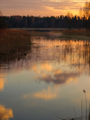 Fototapeta premium picture with abstract and colorful sky reflections in water, suitable for textures