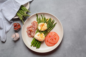 Benedict poached eggs with bacon and fried asparagus for breakfast