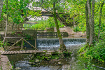 Naklejka premium Beautiful forest landscape with artificial waterfall.