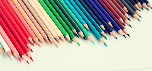 colored pencils lying in irregular row