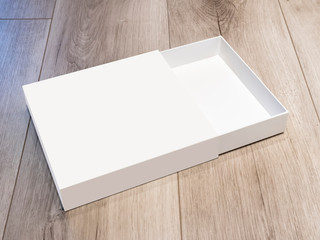 White open cardboard box isolated on wooden surface, mock up