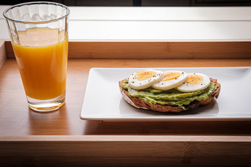 healthy breakfast, advocado toast with eggs and orange juice