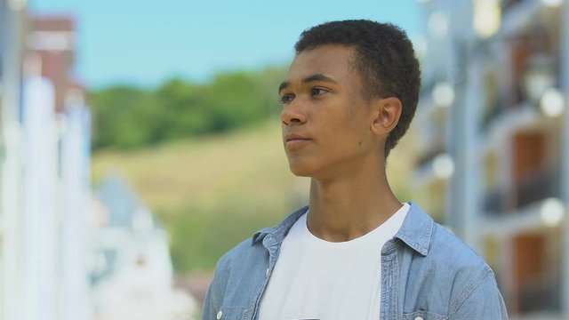 Upset boy holding bible, thinking over religious righteous life, conversion