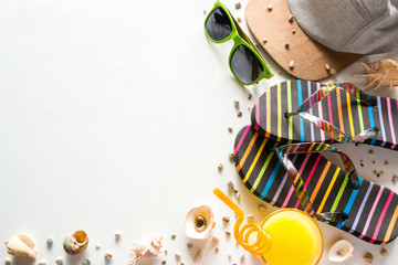 beach shoes, a baseball cap, glasses, juice and shells - beach accessories for summer holidays on a white background mockup