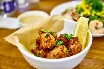 Fototapeta premium Pieces of deep-fried chicken in the Asian style are on the plate.