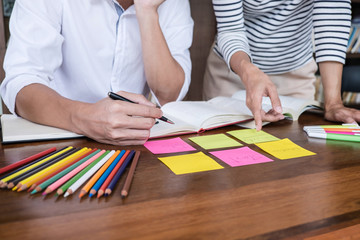 High school or college student group sitting at desk in library studying and reading, doing homework and lesson practice preparing exam to entrance, education concept