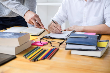 High school tutor or college student group sitting at desk in library studying and reading, doing homework and lesson practice preparing exam to entrance, education, teaching, learning concept