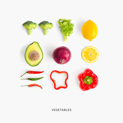 Creative layout made of avocado, red pepper, chili pepper, broccoli, lettuce, onion and lemon. Flat lay. Food concept.