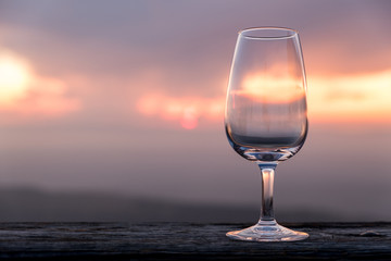 Empty glass of wine in front of a beautiful sunset