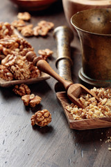 Walnuts in a wooden dish on an old wooden table.