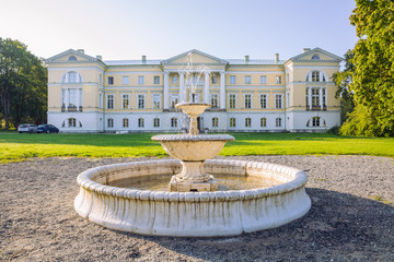 City Mezotne, Latvia Republic. Park with old castle. Fountain and green zone. Sep 9. 2019 Travel photo.