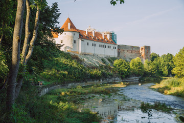 Obraz na płótnie Canvas City Bauska, Latvia Republic. Park with old castle and river. Trees and green zone. Sep 9. 2019 Travel photo.