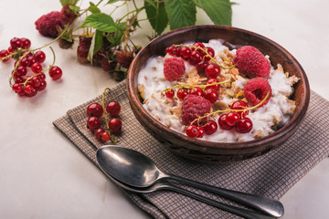 oat flakes breakfast with berries  on wooden background
