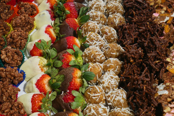 Dessert platter with chocolate strawberries, coconut balls and chocolate crackles