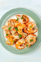 Cooked shrimps with fresh parsley leaves, shot from the top