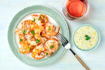 Cooked shrimps with a glass of rose wine and a dip, shot from the top