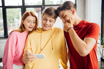 Fototapeta premium three friends taking selfie and smiling in school