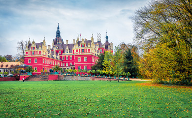 Attractive autumn view of Muskau castle. Rainy morning scene in Muskau Park, UNESCO World Heritage Site, Upper Lusatia region, Saxony, Germany, Europe. Traveling concept background.