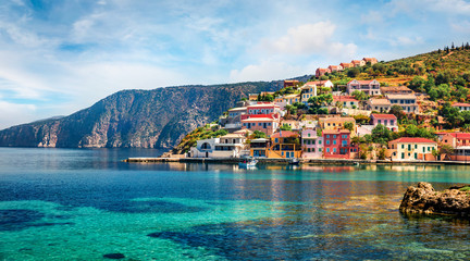 Sunny morning cityscape of Asos village on the west coast of the island of Cephalonia, Greece, Europe. Colorful spring sescape of Ionian Sea. Traveling concept background.