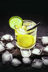 Caipirinha, a typical Brazilian cocktail made with lemon, cachaça, sugar and ice. Brazilian traditional drink, isolated with space for text.