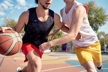 Photo of sportsmen playing basketball on playground on.
