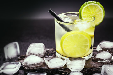 Caipirinha, a typical Brazilian cocktail made with lemon, cachaça, sugar and ice. Brazilian traditional drink, isolated with space for text.