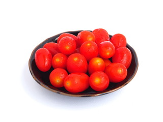 tomato in brown plate on white background.