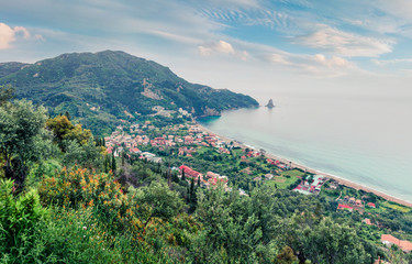 Obraz premium Aerial spring view of holiday resort village Agios Gordios, Achilleio municipality. Fantastic morning seascape of Ionian Sea. Great landscape of Corfu island, Greece, Europe. Instagram filter toned.