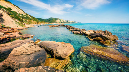 Sunny spring view of small port in Gardenos village. Stunning morning seascape of Ionian Sea. Wonderful landscape of Corfu island, Greece, Europe. Traveling concept background.