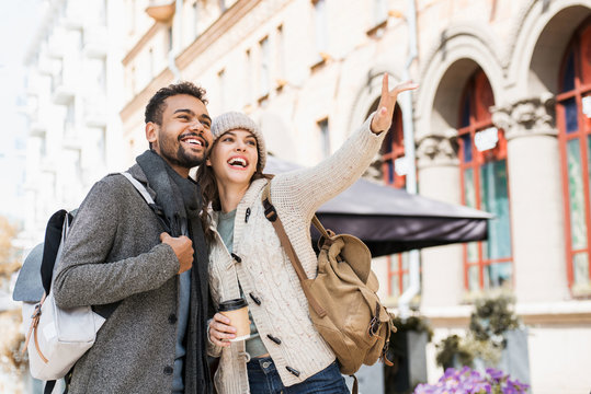 Beautiful Happy Couple Autumn Portrait. Young Joyful Smiling Woman And Man In A City In Winter.  Love, Travel, Tourism, Students Concept