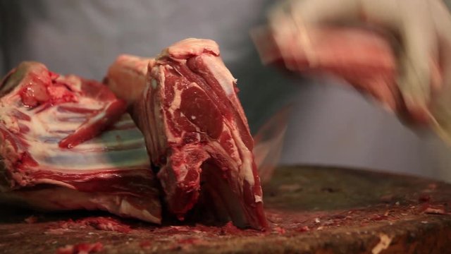 Cutting fresh mutton on wood 
