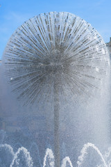 Round fountain against the blue sky. A modern ball-shaped fountain. vertical photo
